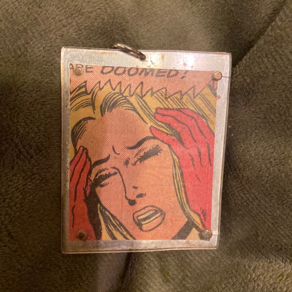 Handmade sterling silver , paper, and plexiglass comic book pendant